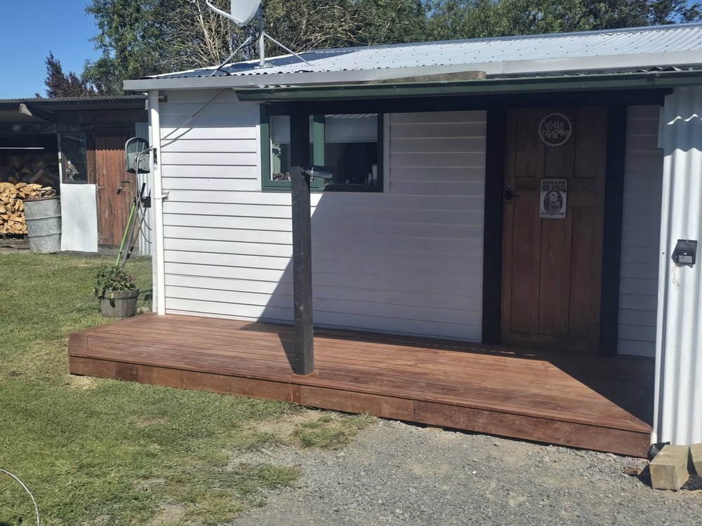 Stained timber veranda deck on the front of a weatherboard cottage